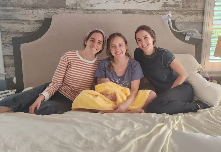 Midwives supporting a mother and newborn after a home birth