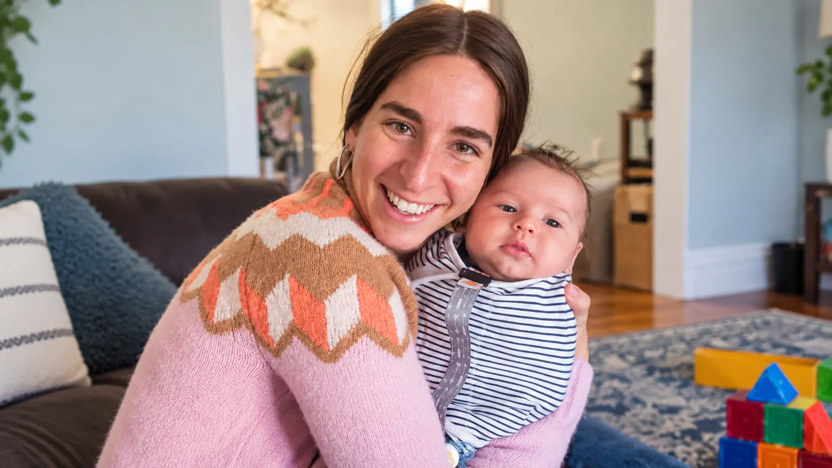 Judy Ribner, DNP, CNM, holding a newborn after a home birth in New York