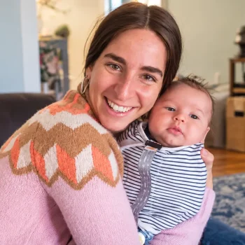 Judy Ribner holding a baby